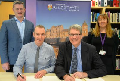 From left to right: Dr Wyn Morris, Alun Jones, Professor Tim Woods and Laura McSweeney signing the new contract