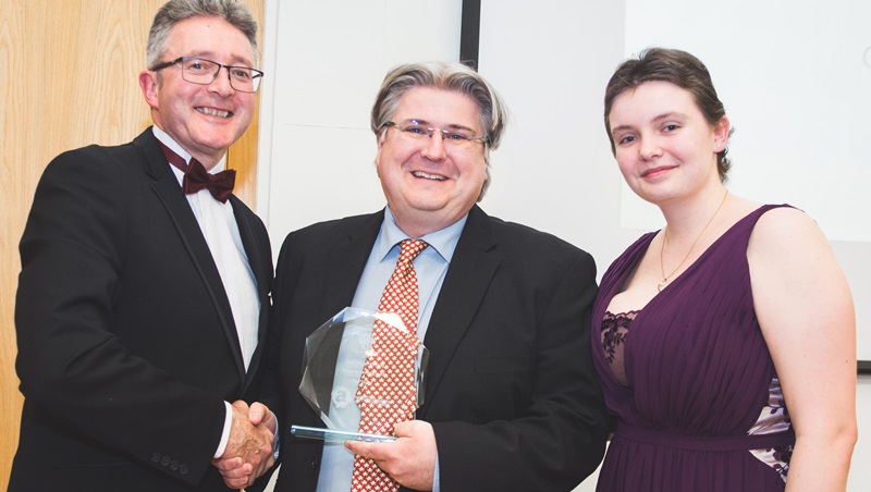 Dr Neil Taylor (centre) from the Department of Computer Science receiving the Outstanding Teaching Award from Lauren Marks, Aberystwyth Students’ Union Education Officer and Professor John Grattam, Acting Vice-Chancellor at the 2016 Student-Led Teaching Awards. Credit: Alex Stuart & AJFS Photography