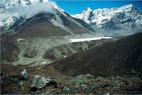 Imja Tsho with its wide, complex moraine dam. The debris-covered Imja Glacier is at the far right, beyond the frozen surface of the lake. Nepal. Photo: M. J. Hambrey.