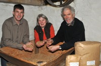 Dr. Huw McConochie from IBERS (left) with Anne and Andrew Parry at the Felin Ganol water mill.