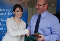 School of Management and Business student Alexandra Gencheva presents a University scarf to George Ashworth of Aldemore Bank.