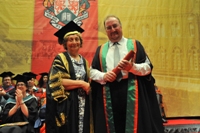 Neil Brand receiving his Fellowship from Vice-President Mrs Elizabeth France CBE