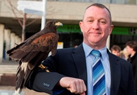 Aberystwyth University’s Director of Health and Safety, Phil Maddison with Harris Hawk, ‘Hope’.