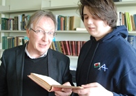 Dr Robin Chapman (left) and Robin Williams, a second year student studying Welsh and Welsh History, reading one of T Gwynn Jones’ books
