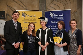 Vice Chancellor of Aberystwyth University, Professor April McMahon (centre) with MIND Aberystwyth staff, left to right: Tim Bennett, Eleanor Parker, Jennie Thomas and Bethan Roberts