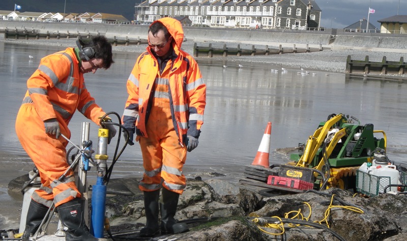 Drill-coring artificial rock pools at Tywyn. Led by Aberystwyth University, Ecostructure will boost biodiversity on coastal structures in Wales and Ireland by enhancing the ecological value of coastal defence and renewable energy structures in Wales and Ireland.