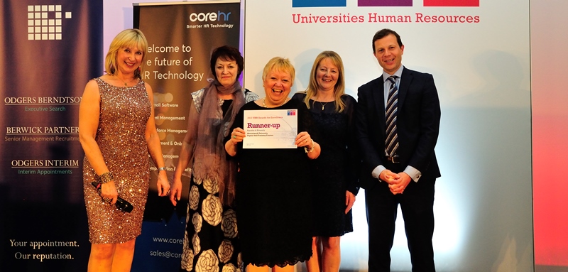Lesley Spees (centre) and Sue Chambers (second from left) from Aberystwyth University’s Human Resources team receive recognition for the good work done on digital skills training at the annual UK Universities Human Resources (UHR) Awards.