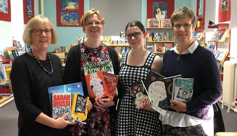 Pictured in the Resources Library at the Welsh Books Council headquarters in Aberystwyth are (l-r) Joanna Jeffrey, lecturer in Education at Aberystwyth University; Sarah Gwenlan, education librarian at Aberystwyth University; student Samantha Attfield, and Helen Jones, Head of Children’s Book and Reading Promotion at the Welsh Books Council.