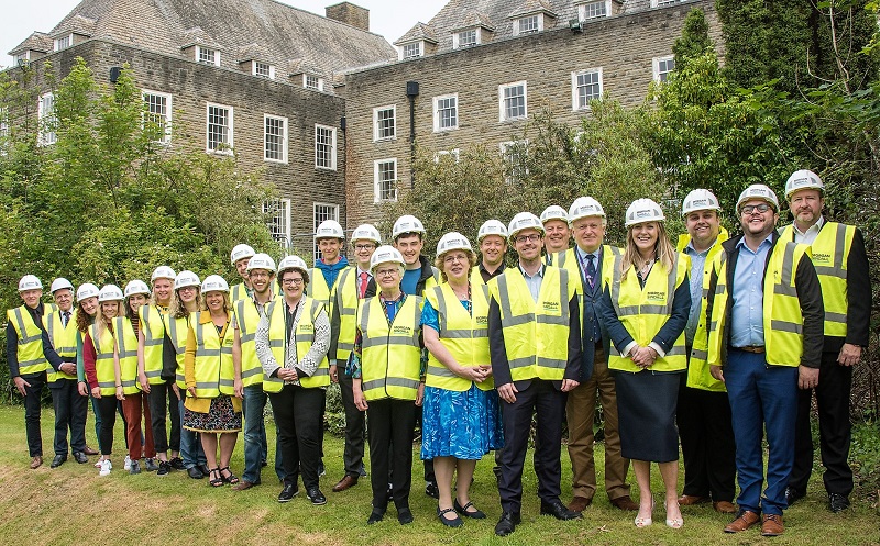 Professor Elizabeth Treasure, Vice-Chancellor of Aberystwyth University (4th from right), Gwerfyl Pierce Jones, Chair or the Pantycelyn Project Board (5th from right), and Gerallt Evans (3rd from right) from Morgan Sindall, along with students and representatives from the University and Morgan Sindall, mark the awarding of the contract for the renovation of Pantycelyn.