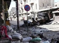 Cerbydau wedi ei bomio yn ninas Aleppo yn ystod rhyfel cartref Syria. Llun: Voice of America News.