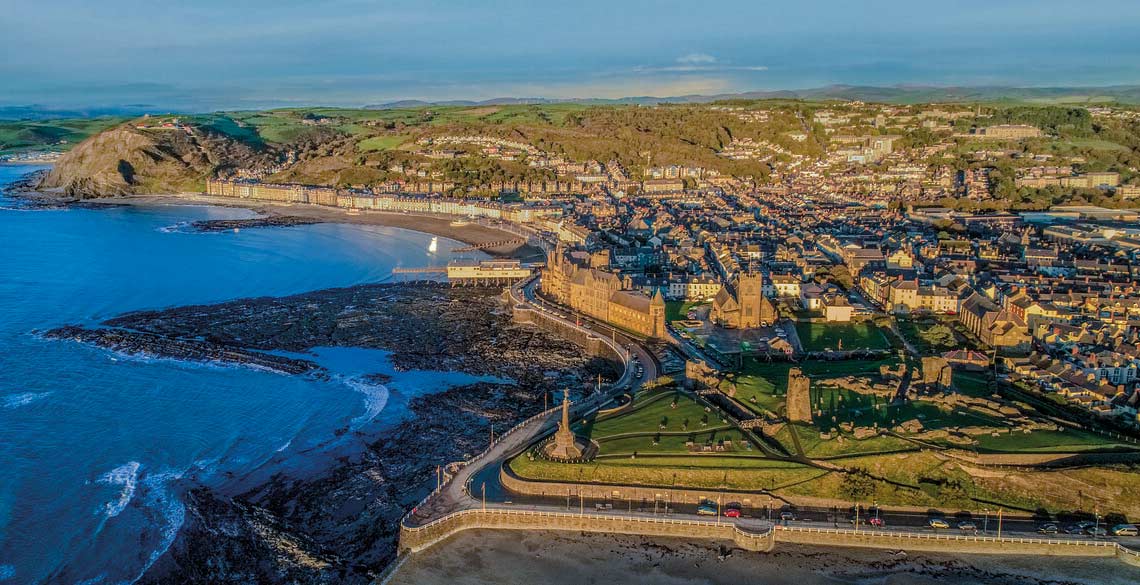 Aerial image of Old College, Promenade, Aberystwyth town centre and Penglais Hill in the background. 