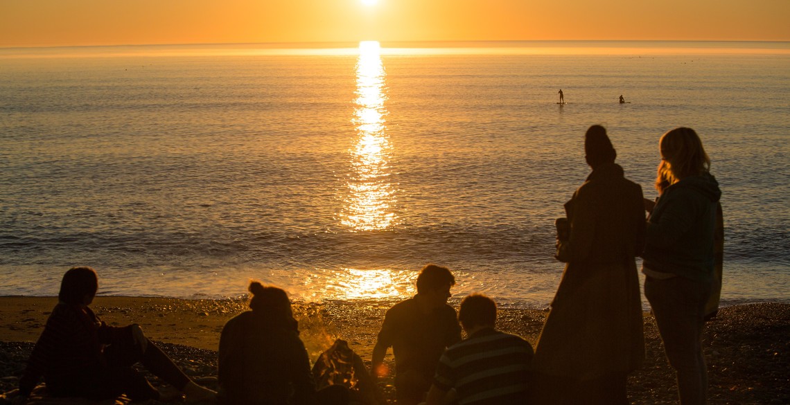 Students on the beach watching the sunset