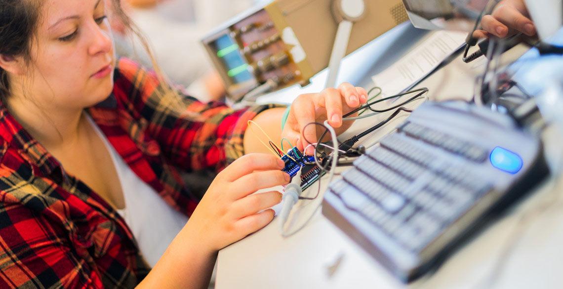 Female student connecting wires