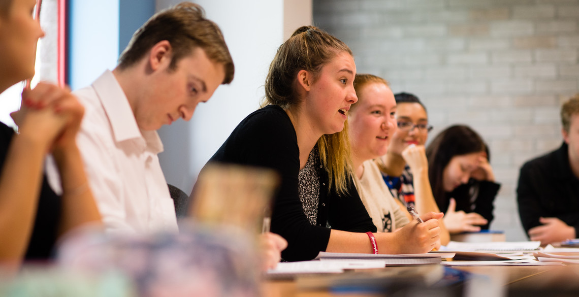 Students in seminar engaging with lecturer