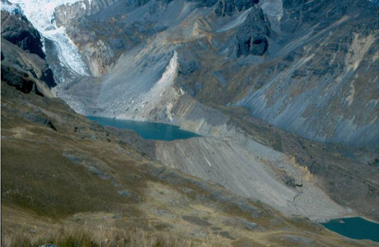 The moraine-dammed lake at Safuna. A large-landslide in 2002 fell into the far side of the lake, covering the glacier terminus and creating a wave over 100 metres high. The light-coloured areas of the moraine show where the wave splashed over the moraine and partly eroded it. The lake level is low because tunnels were excavated through the moraine to reduce the potential for breaching. Nevertheless the rockfall-generated wave almost resulted in failure. Photo: B. Hubbard.