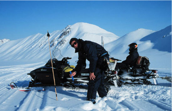 Neil Glasser fixing sampling locations on Midtre Lovénbreen using a GPS. Photo: M. J. Hambrey.
