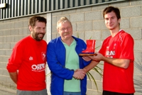 Professor Wayne Powell (centre) presenting the 'Welly Cup' to student captain Sam Wright