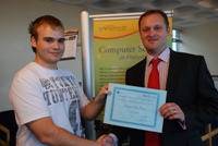 Final year student Sam Thomas receives the Portaltech Student Bursary from Paul Tough.