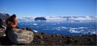 British Antarctic Survey field assistant Alan Hill sampling an erratic granite boulder on James Ross Island, Antarctica.