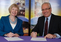 Professor April McMahon, Vice-chancellor of Aberystwyth University, and Mr Trevor Purt, Chief Executive of Hywel Dda Health Board, sign the Memorandum of Understanding.