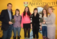 Left to right: Dr Bleddyn Huws, Gwenno Edwards, Ffraid Gwenllian, Elin Haf Gruffydd, Llinos Jones and Efa Gruffudd Jones, Chief Executive of the Urdd.