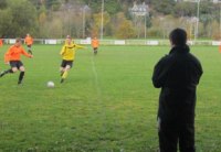 In play, Dave looks on as his team challenges for the ball