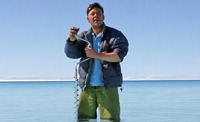 Dr Alun Hubbard drilling into the ice below a lake in Greenland