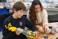 Penglais student Iestyn Langstaff and Aberystwyth University student ambassador Pheobe Holcombe working on a 3D humanoid robotic arm at the Aberystwyth Robotics Club