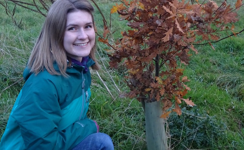 Catherine Duerden with a tree shelter