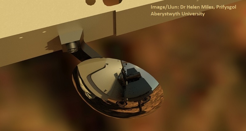 The Rover Inspection Mirror (RIM), as seen from the High Resolution Camera (HRC). When the drill is collecting a sample, the RIM allows PanCam to see underneath the drill box - in this image the rover is in the process of drilling to collect a sample of Martian rock.