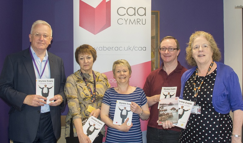 Aberystwyth University Vice-Chancellor Professor Elizabeth Tresure (right) receives a copy of Wynne Evans – o Gaerfyrddin i Go Compare from Delyth Ifan, Director of CAA Cymru (Centre). Also pictured (left to right) is Stephen Forster, Director of Finance, Susan Chambers, Director of Human Resources and Welsh Learning Tutor Rob Dery.
