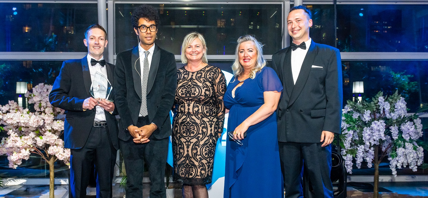 Left to right: Aberystwyth University staff members Adrian Sutton, Beth Roberts, Faye Ap Geraint and Tamas Gyorgy receive the Whatuni Student Choice Awards’ Halls and Student Accommodation prize from actor Richard Ayoade (second left).