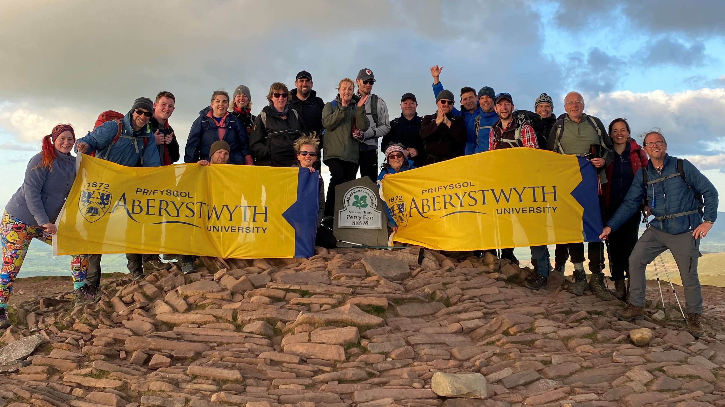 Celebrating on the summit of Pen y Fan: Staff from Aberystwyth University completed the Welsh Three Peaks Challenge in just 16 hours.