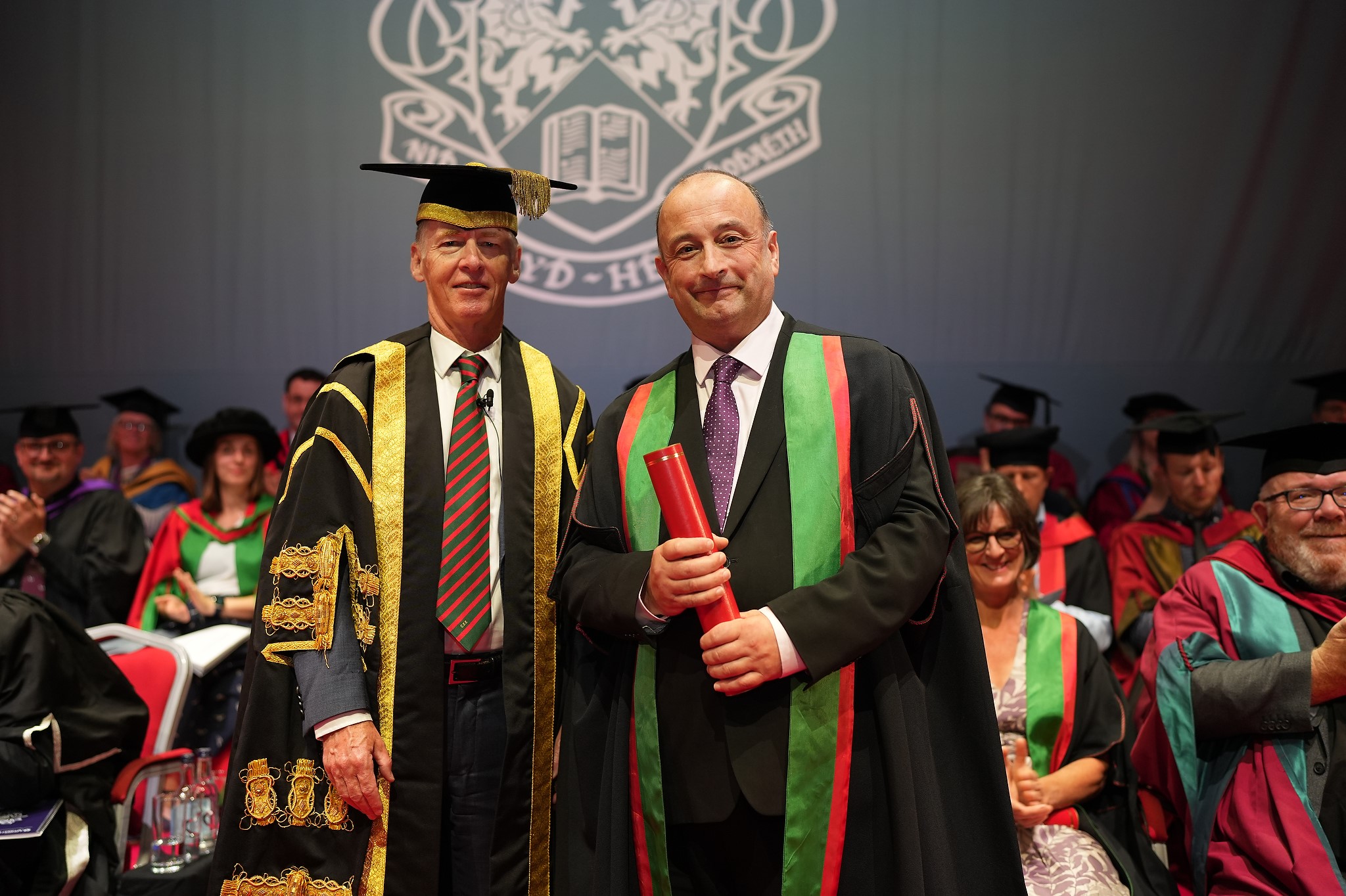 Dr Emyr Roberts, Chair of Aberystwyth University Council, presenting an Honorary Fellowship to Phil Thomas
