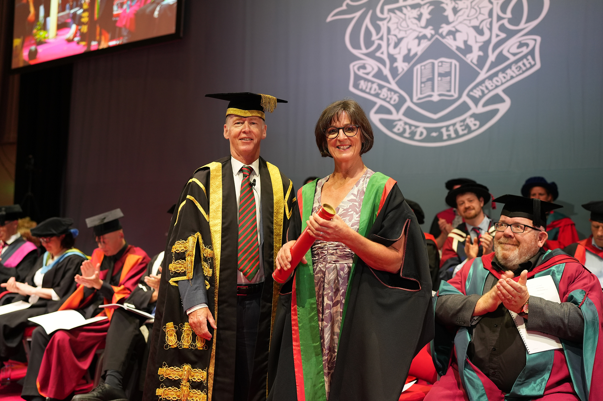 Dr Emyr Roberts, Chair of Aberystwyth University Council, presenting an Honorary Fellowship to Dr Kate O'Sullivan