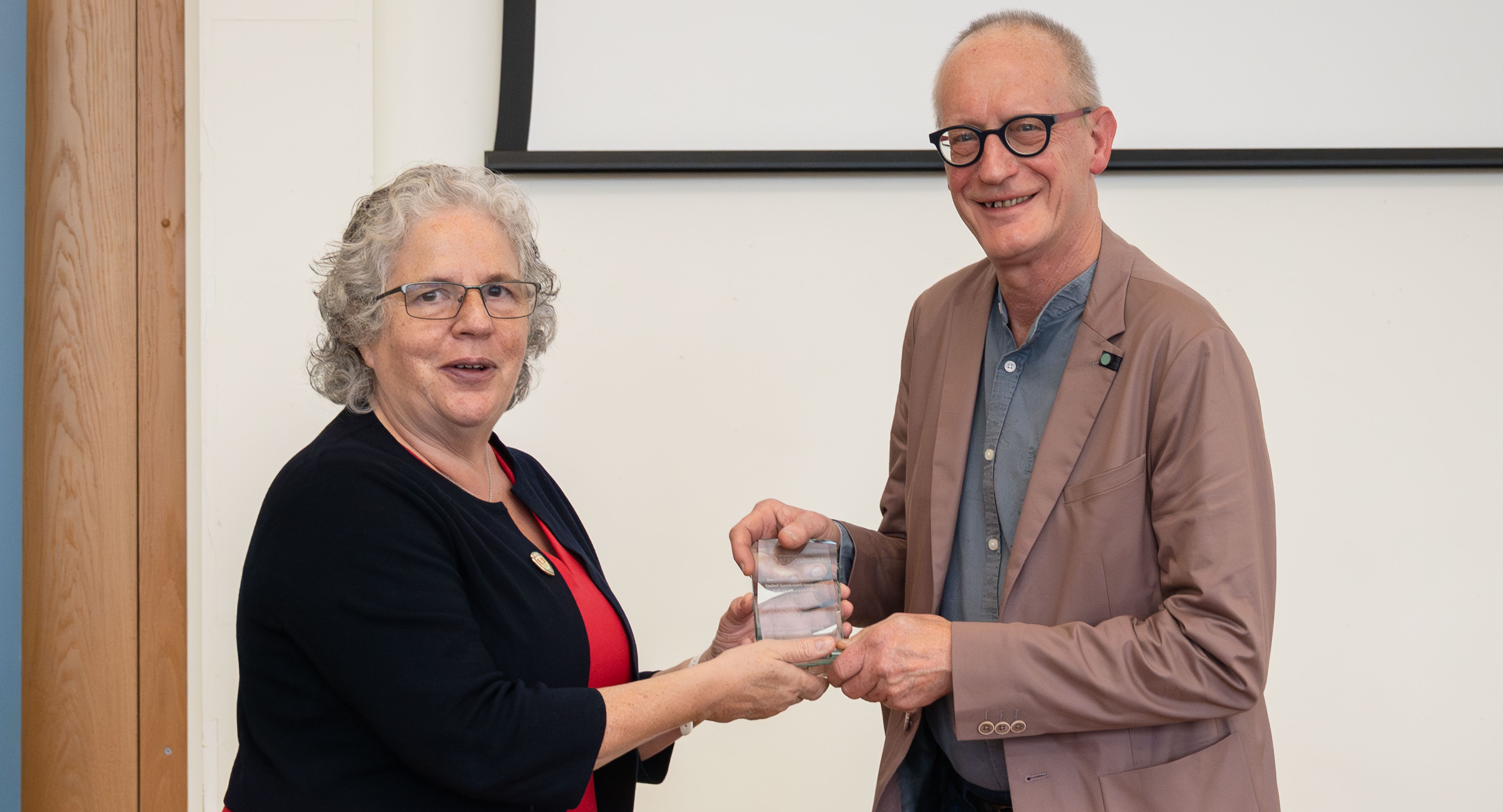 Professor Elizabeth Treasure, Vice-Chancellor of Aberystwyth University, presenting the Award for Exceptional Research Impact to Professor Ryszard Piotrwicz.