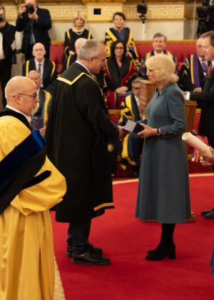 Aberystwyth University Vice-Chancellor Professor Jon Timmis receiving the award from Her Majesty The Queen at Buckingham Palace