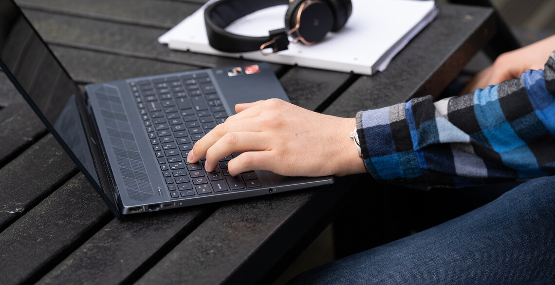 Hand typing on laptop.