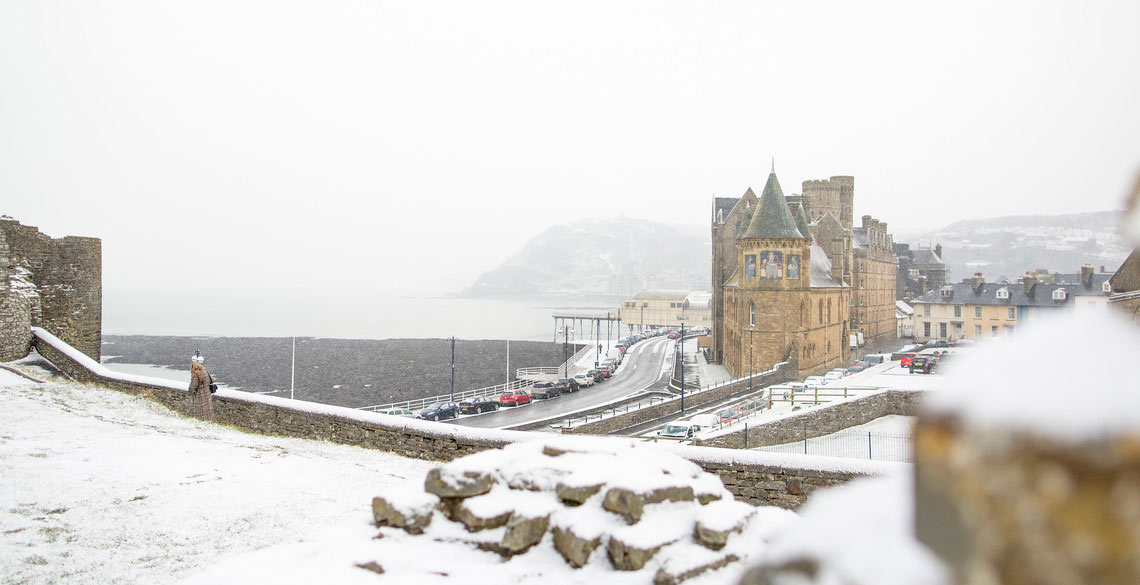 Snow fall on the Old College and Aberystwyth North Promenade. 