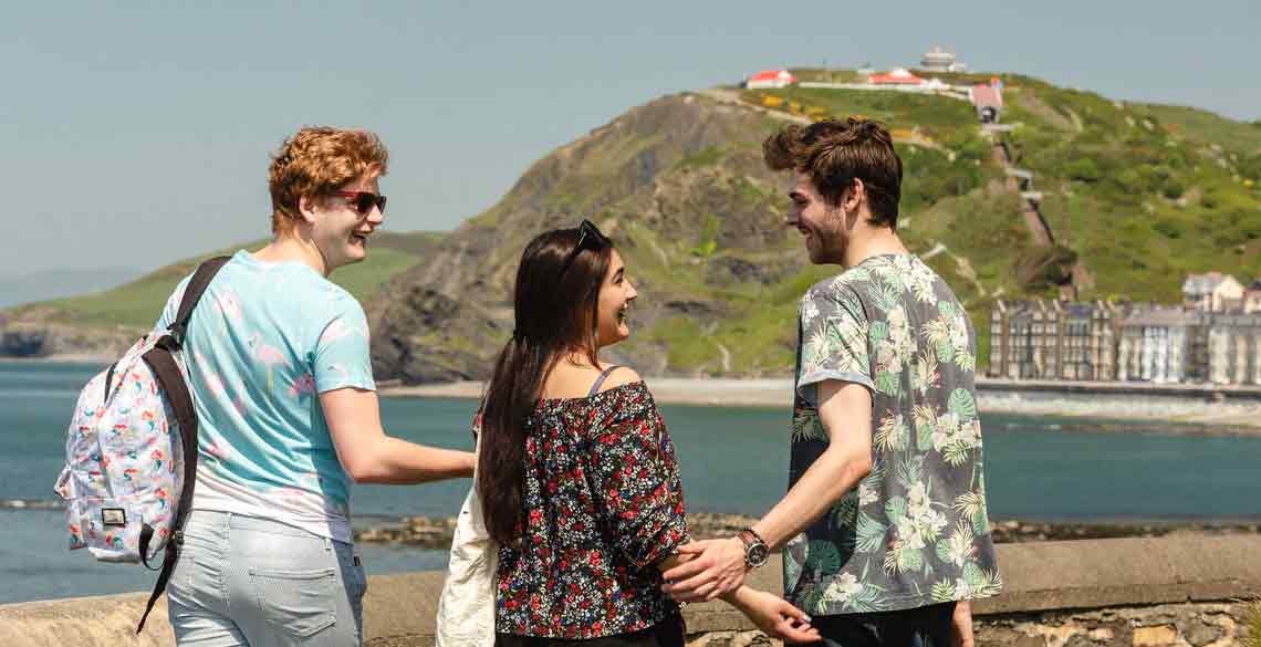 Students exploring Aberystwyth with Constitution Hill in the background. 