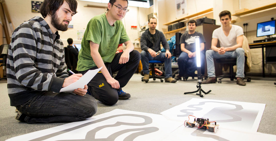 students playing with robots. 