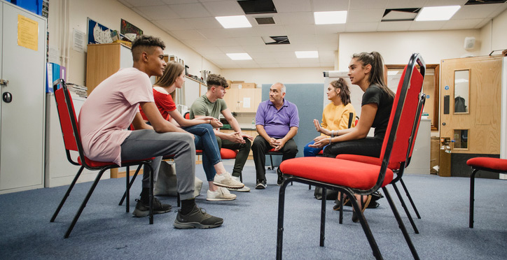 a group of students meeting. 