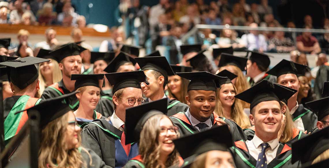 Students graduating in the Great Hall, Arts Centre, Aberystwyth University.