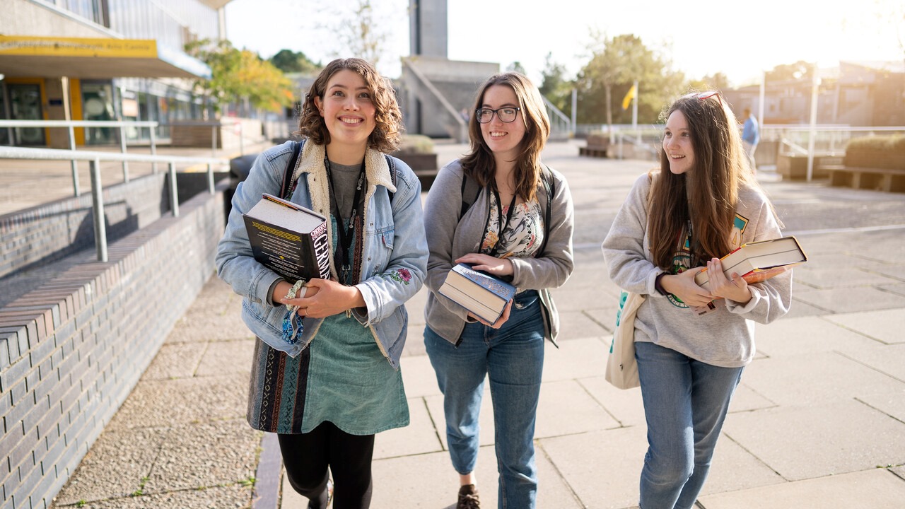 3 students walking on campus