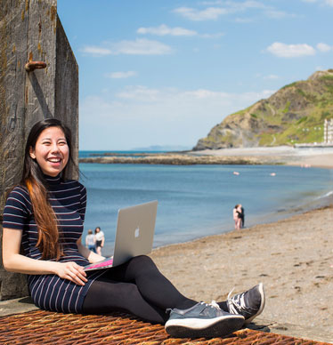 Photo of a student with a laptop on the prom